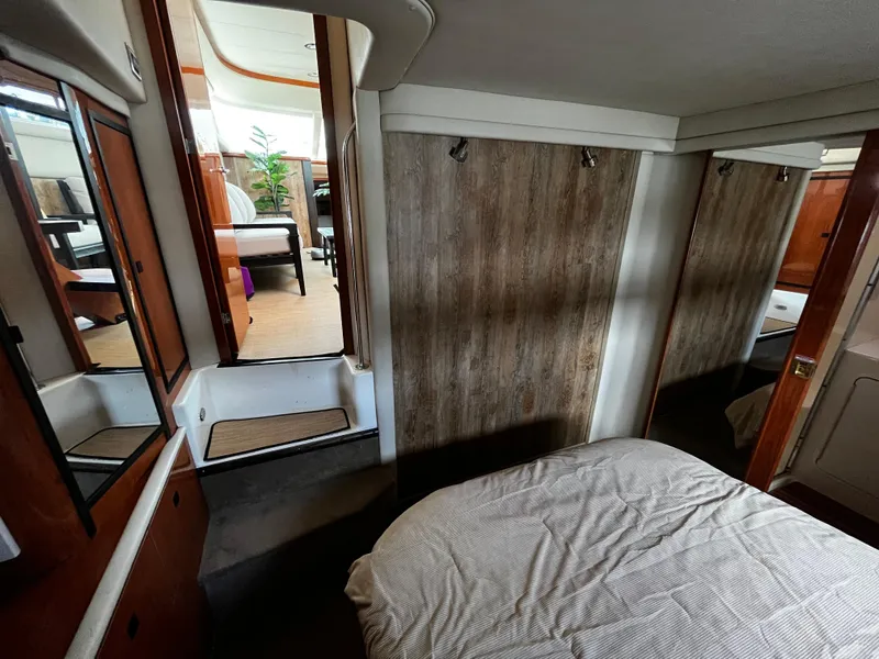 Slide: The Image of Interior of 2001 Sea Ray 420 Aft Cabin, featuring cozy bedroom and wooden accents. - 48