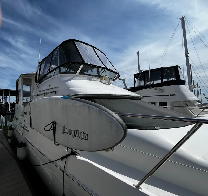 Slide: The Image of 2001 Sea Ray 420 Aft Cabin yacht docked under a clear blue sky. - 6