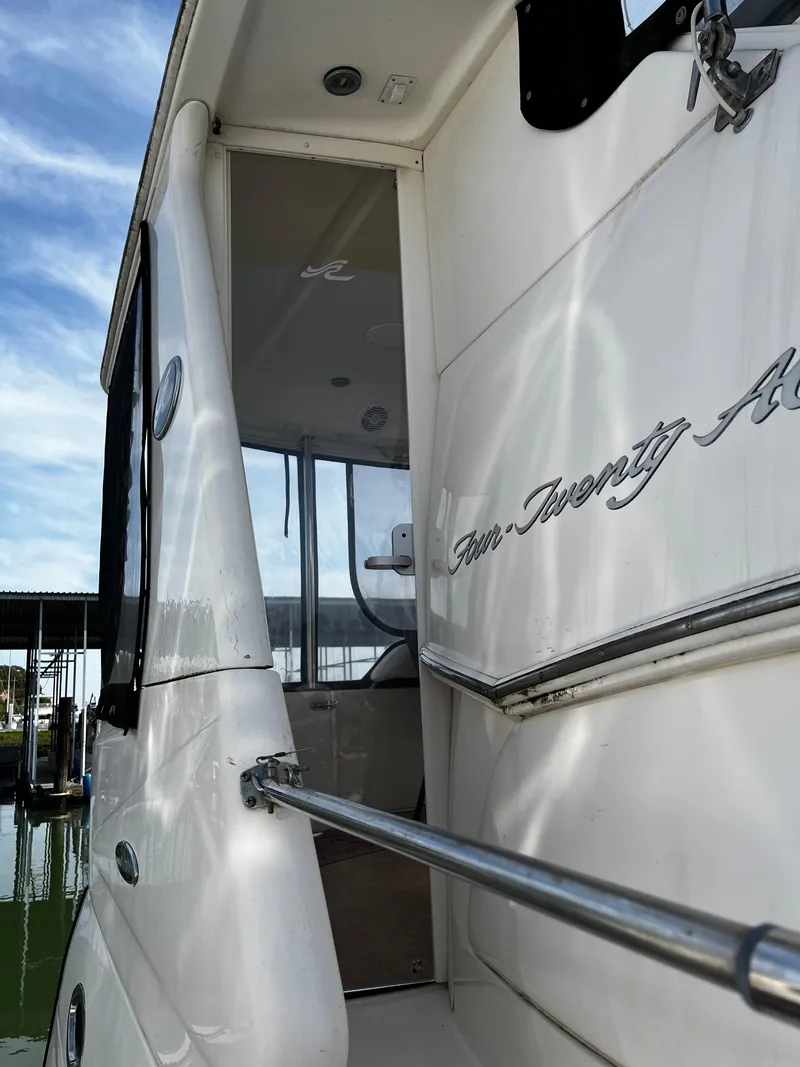 Slide: The Image of 2001 Sea Ray 420 Aft Cabin yacht exterior with sleek design and chrome railing. - 7