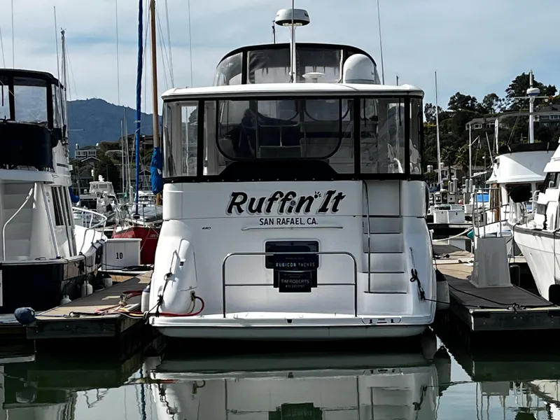 Slide: The Image of 2001 Sea Ray 420 Aft Cabin yacht docked in marina, named "Ruffin' It". - 9