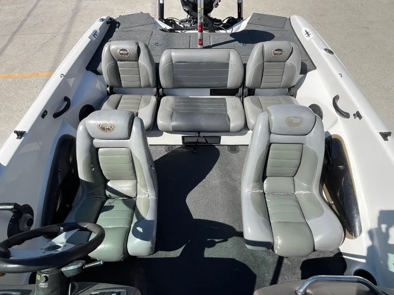 Slide: The Image of 2007 Triton 190 FS boat interior with gray seating and steering wheel. - 11