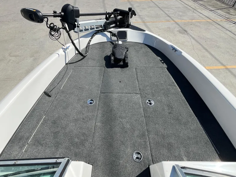 Slide: The Image of 2007 Triton 190 FS boat deck with trolling motor and carpeted surface. - 13