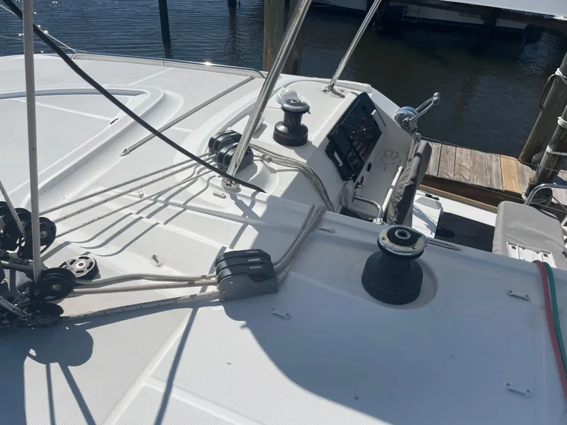 Slide: The Image of 2017 Lagoon 39 sailboat deck with winches and ropes, docked at marina. - 12