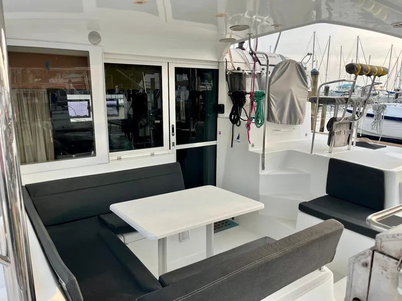 Slide: The Image of 2017 Lagoon 39 yacht cockpit with seating, table, and marina view. - 15
