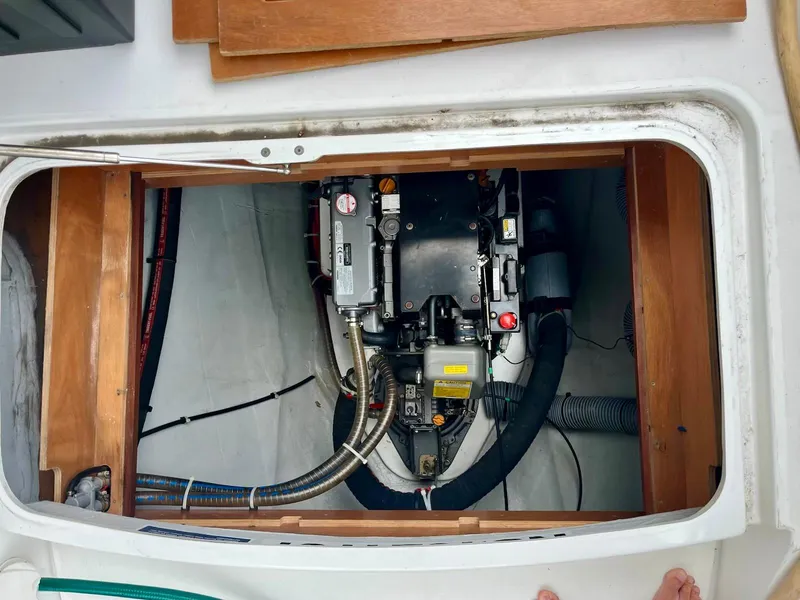 Slide: The Image of Engine compartment of a 2017 Lagoon 39 catamaran, showcasing mechanical components and wiring. - 24