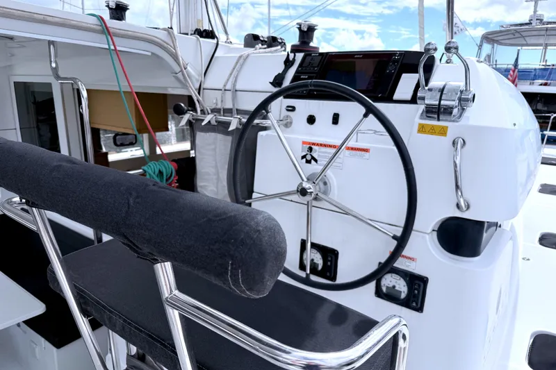 Slide: The Image of Steering wheel and controls of a 2017 Lagoon 39 catamaran, featuring modern navigation equipment. - 3