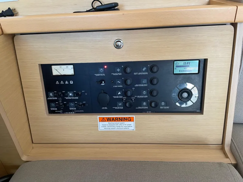 Slide: The Image of Control panel of a 2017 Lagoon 39 yacht with various switches and warning label. - 34