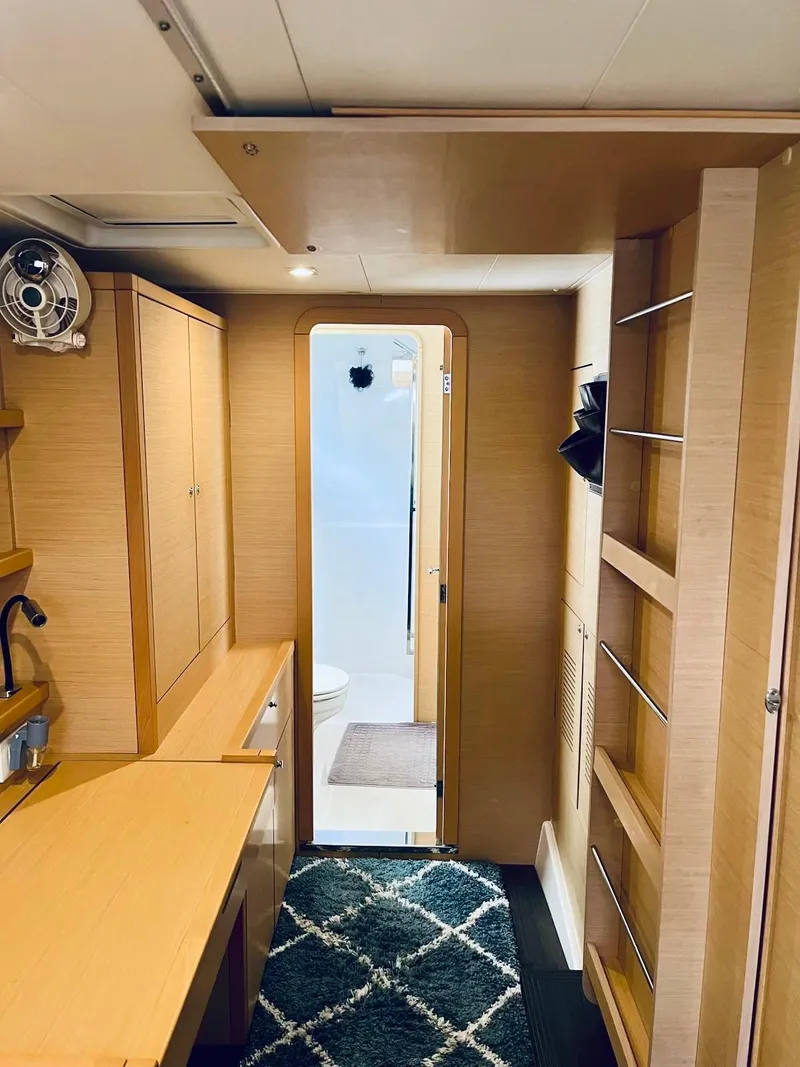 Slide: The Image of Interior of 2017 Lagoon 39 catamaran featuring modern wood cabinetry and compact bathroom. - 39