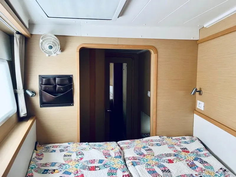 Slide: The Image of Cozy cabin interior of 2017 Lagoon 39 catamaran with colorful quilted bedding. - 44