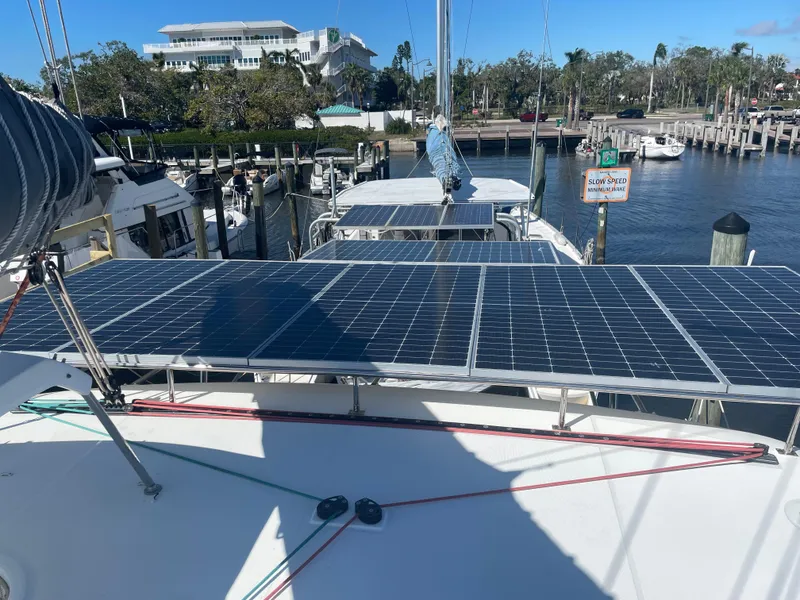 Slide: The Image of 2017 Lagoon 39 catamaran with solar panels docked at a marina. - 6