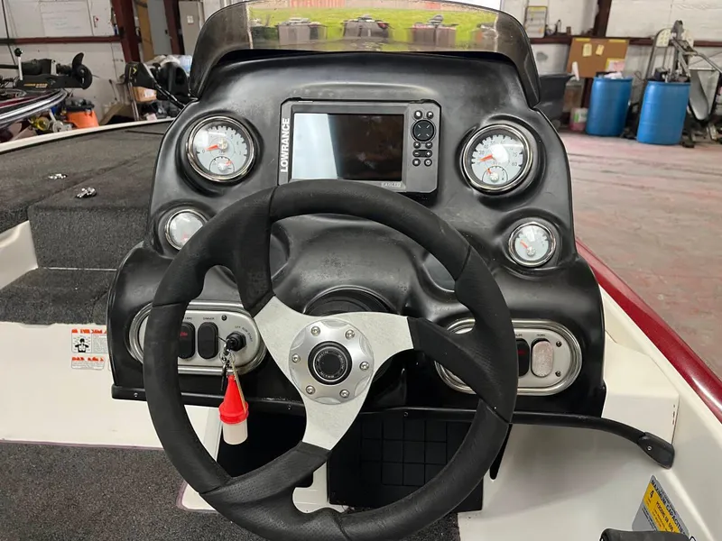 Slide: The Image of Steering console of a 2015 Nitro Z7 boat with gauges and a Lowrance display. - 13
