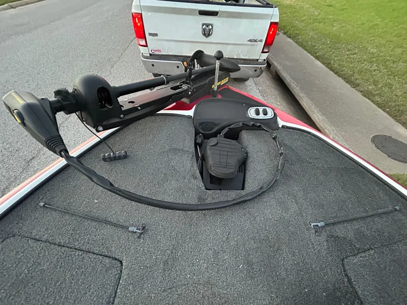 Slide: The Image of 2015 Nitro Z7 boat with trolling motor, parked near a white truck. - 22