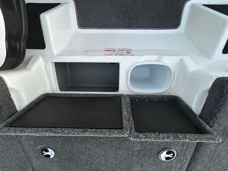 Slide: The Image of 2015 Nitro Z7 boat storage compartments with carpeted interior and secure latches. - 24