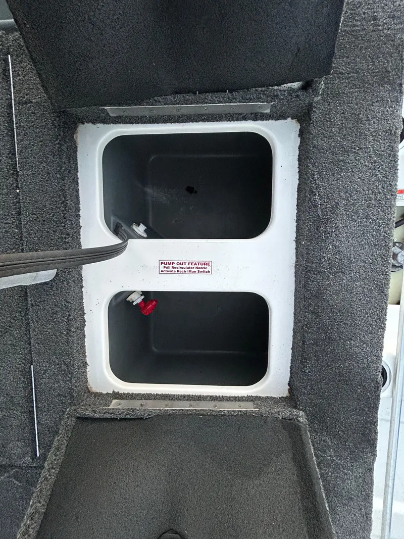 Slide: The Image of Nitro Z7 2015 boat storage compartments with carpeted interior and dual openings. - 25