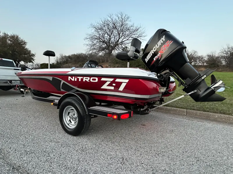 Slide: The Image of 2015 Nitro Z7 boat with Mercury engine on trailer, parked on roadside. - 3