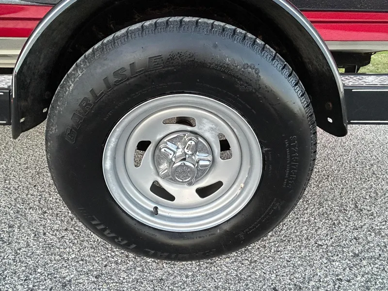 Slide: The Image of Trailer wheel with Carlisle tire on a 2015 Nitro Z7 boat trailer. - 44