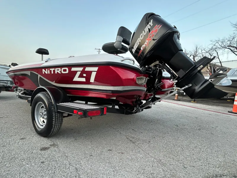 Slide: The Image of 2015 Nitro Z7 boat with Mercury engine on trailer, parked outdoors. - 54