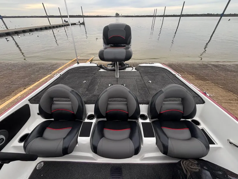 Slide: The Image of Nitro Z7 2015 boat interior with four black and gray seats by the water. - 8