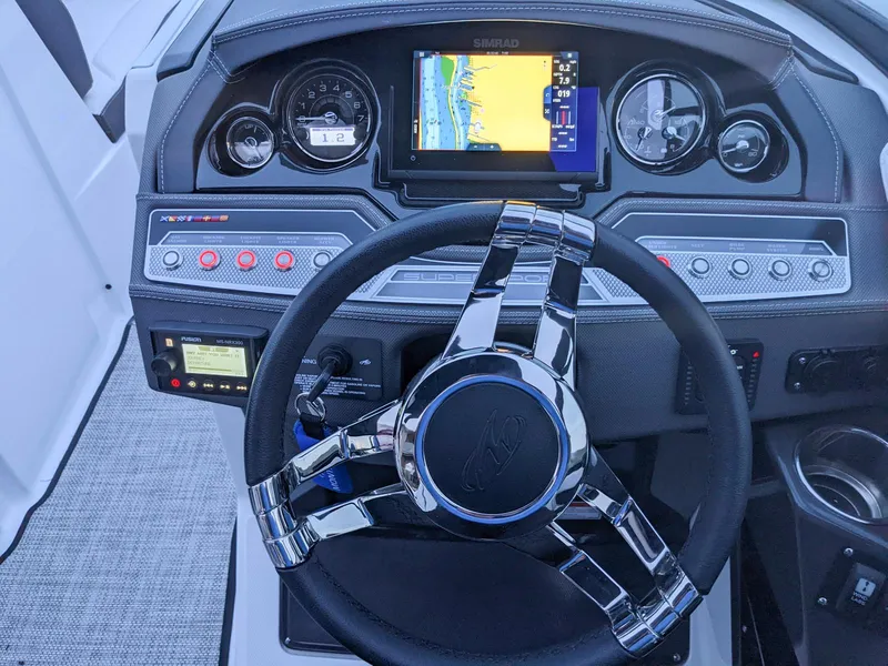 Slide: The Image of Dashboard of 2022 Monterey 258 Super Sport boat with steering wheel and navigation display. - 11