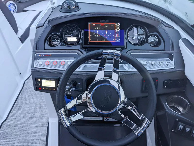 Slide: The Image of 2022 Monterey 258 Super Sport dashboard with modern controls and navigation system. - 12