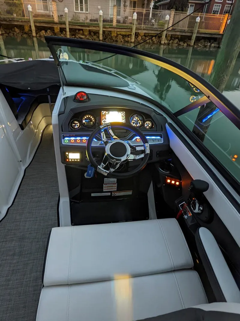 Slide: The Image of 2022 Monterey 258 Super Sport boat interior with modern dashboard and steering wheel. - 16