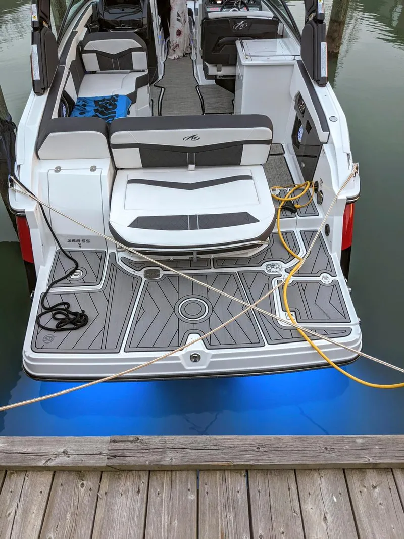 Slide: The Image of 2022 Monterey 258 Super Sport boat docked with illuminated deck and seating area. - 18