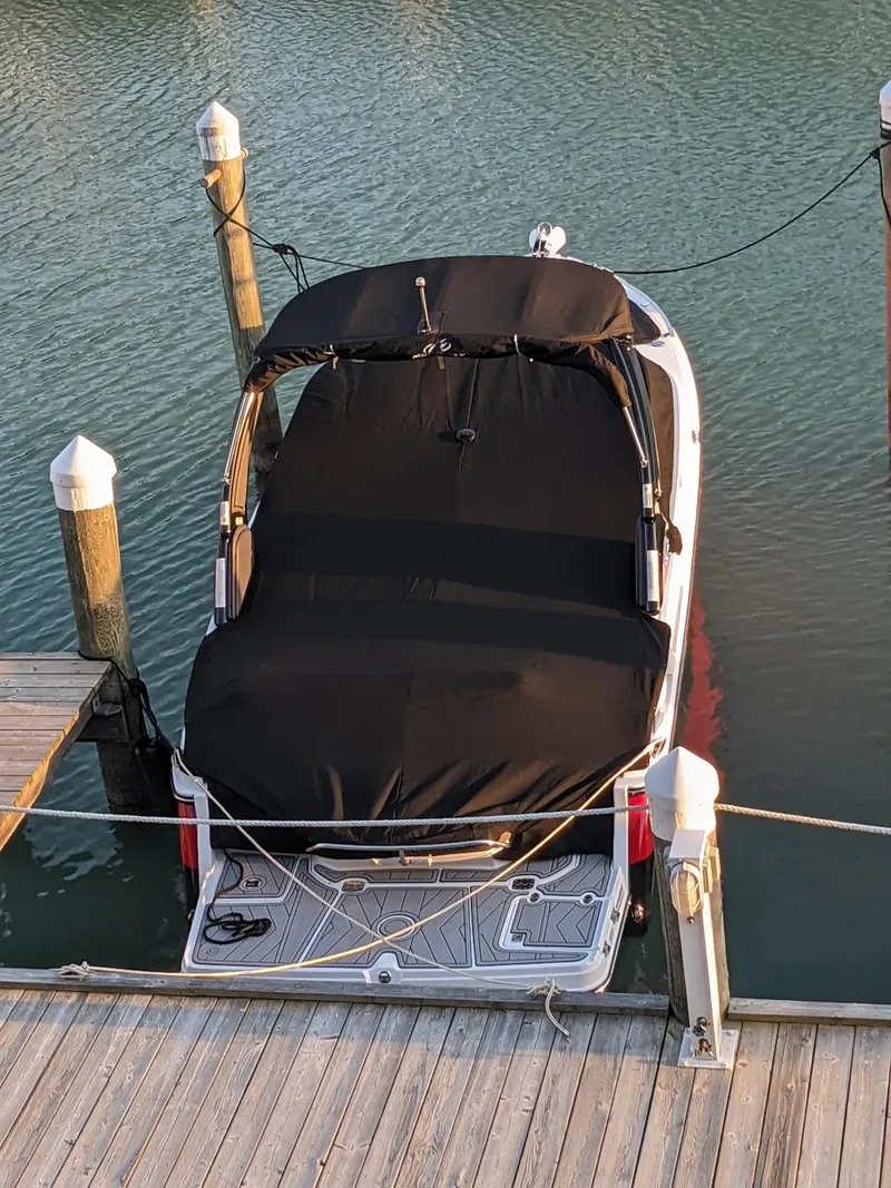 Slide: The Image of 2022 Monterey 258 Super Sport boat docked with black cover, viewed from above. - 20
