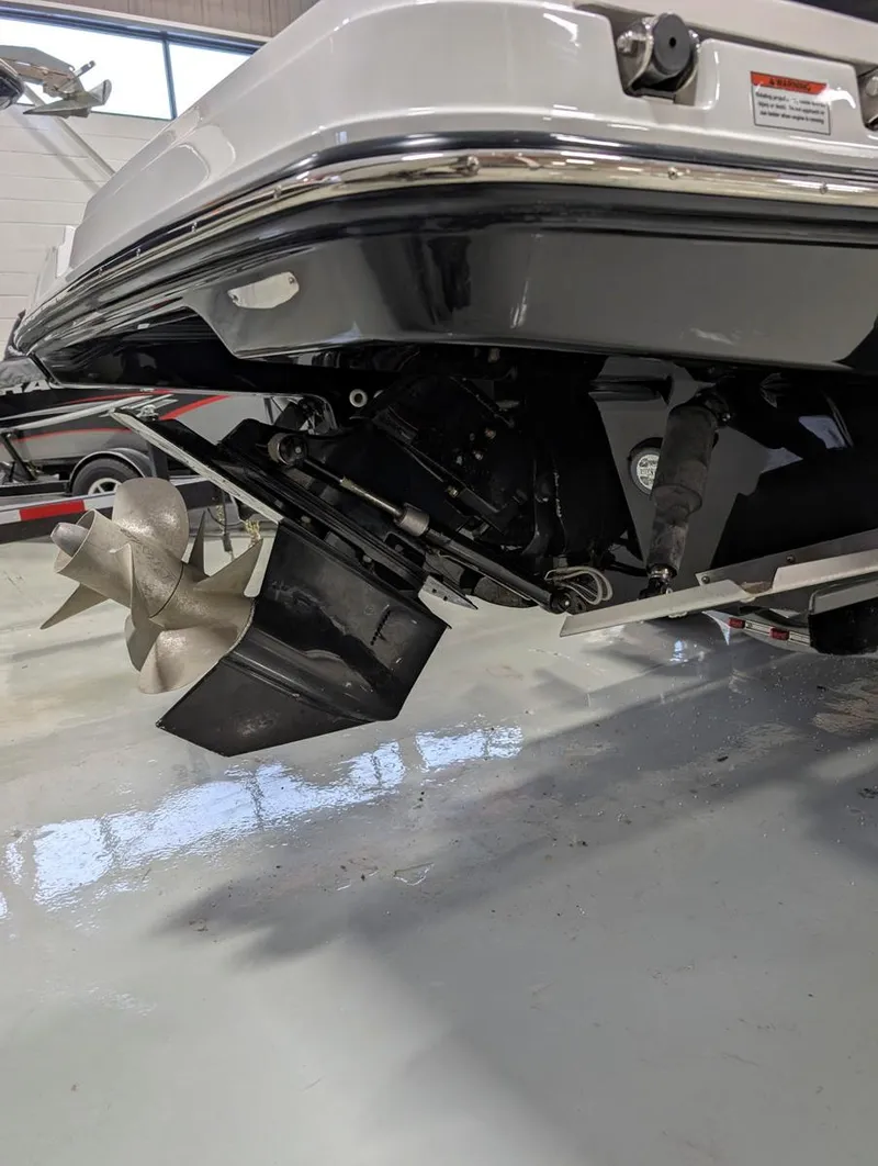 Slide: The Image of 2022 Monterey 258 Super Sport boat propeller and stern in a showroom. - 26
