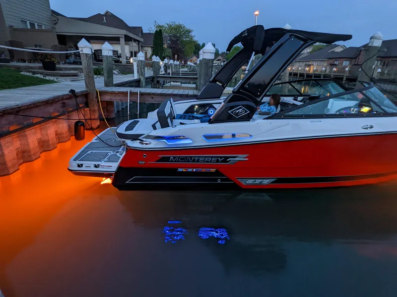 Slide: The Image of 2022 Monterey 258 Super Sport boat docked with underwater lights glowing. - 3