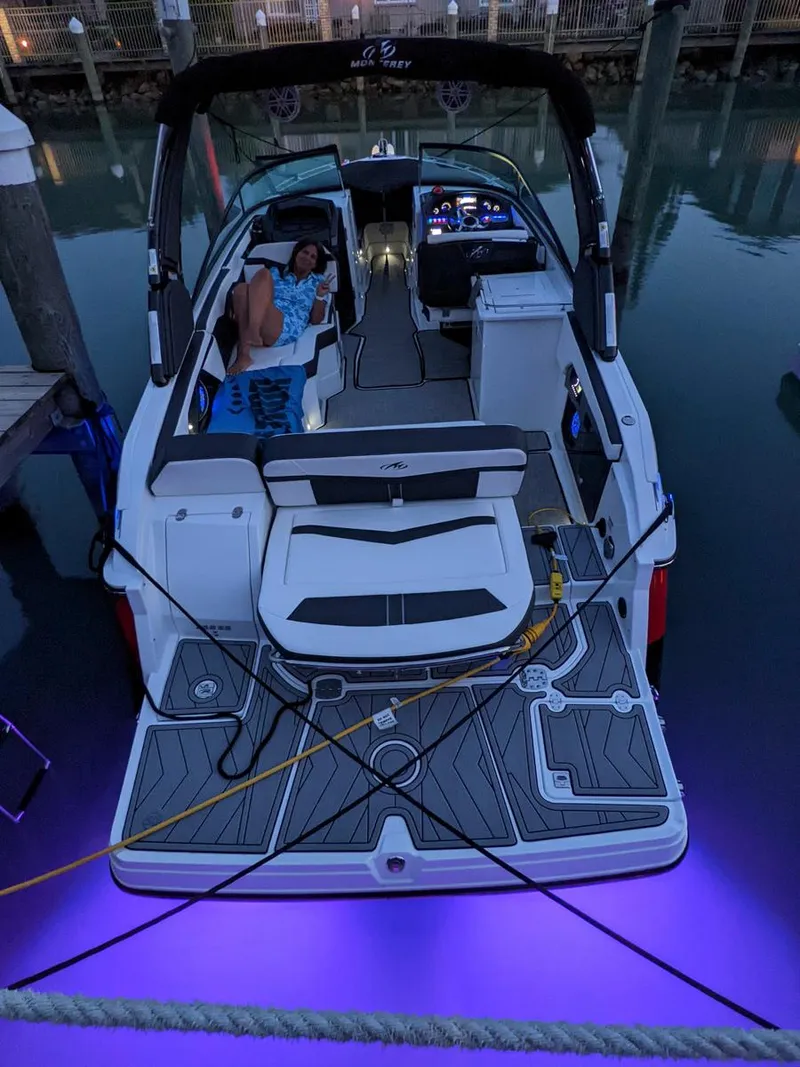 Slide: The Image of 2022 Monterey 258 Super Sport boat with purple underwater lights at dock. - 5