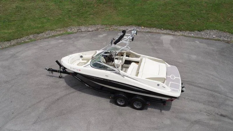 Slide: The Image of 2007 Sea Ray 210 Select boat on trailer, parked on paved surface, aerial view. - 11