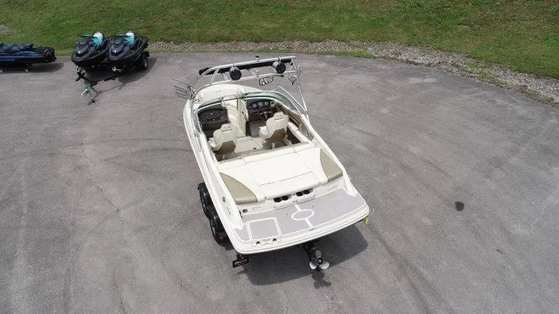 Slide: The Image of 2007 Sea Ray 210 Select boat on trailer, parked near green grass. - 13