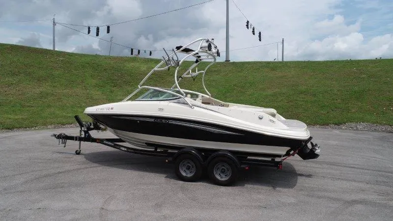 Slide: The Image of 2007 Sea Ray 210 Select boat on trailer, parked outdoors under cloudy sky. - 19