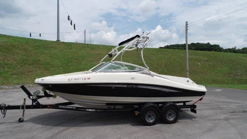 Slide: The Image of 2007 Sea Ray 210 Select boat on trailer, parked outdoors under cloudy sky. - 21