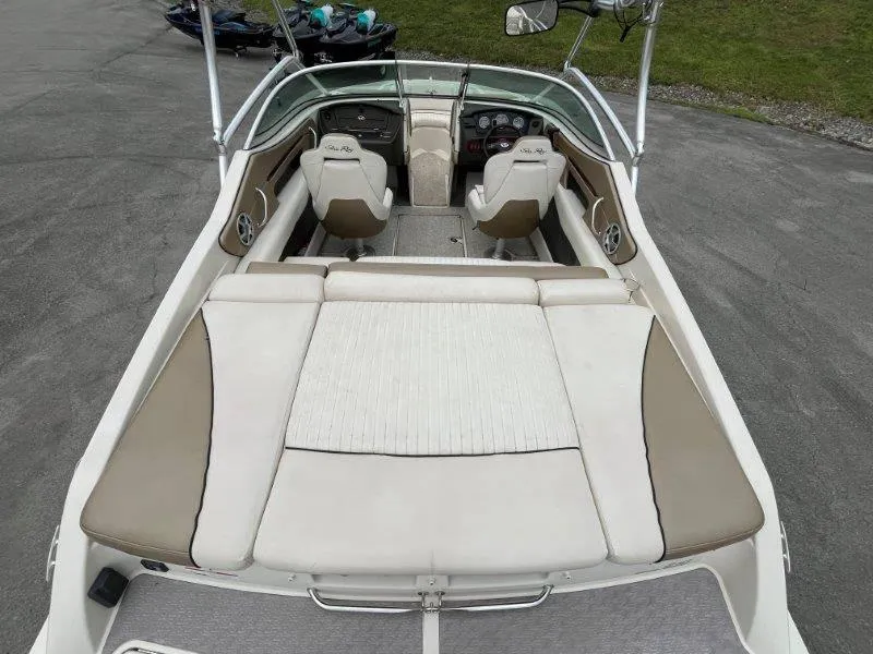 Slide: The Image of 2007 Sea Ray 210 Select boat interior with beige seating and dashboard view. - 24