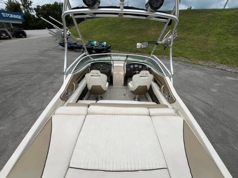 Slide: The Image of 2007 Sea Ray 210 Select boat interior with seating and dashboard, parked on pavement. - 25