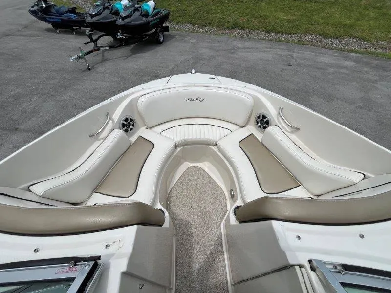 Slide: The Image of 2007 Sea Ray 210 Select boat interior with beige seating and speakers. - 26