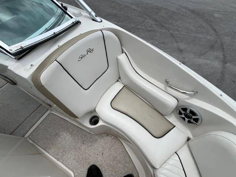 Slide: The Image of 2007 Sea Ray 210 Select boat interior with white seating and speaker. - 28