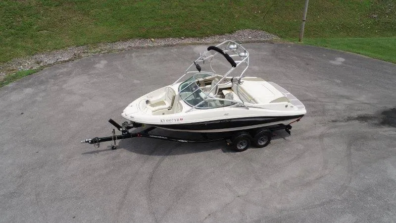 Slide: The Image of 2007 Sea Ray 210 Select boat on trailer, parked on paved surface. - 3