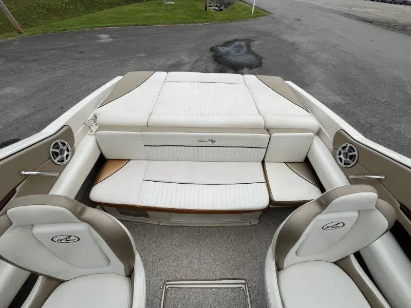 Slide: The Image of 2007 Sea Ray 210 Select boat interior with white seating and speakers. - 30