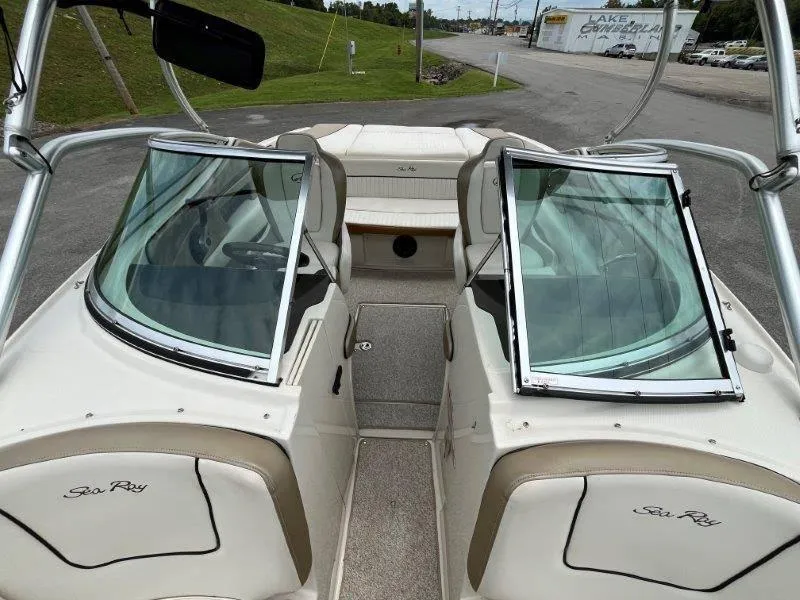 Slide: The Image of 2007 Sea Ray 210 Select boat interior with open windshield and seating area. - 31