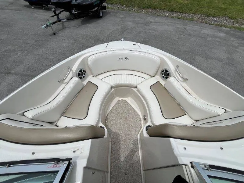 Slide: The Image of 2007 Sea Ray 210 Select boat interior with beige seating and carpeted floor. - 32