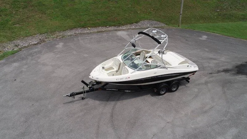 Slide: The Image of 2007 Sea Ray 210 Select boat on trailer, parked on paved surface. - 4