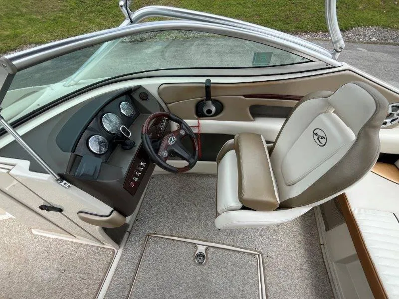 Slide: The Image of 2007 Sea Ray 210 Select boat interior with steering wheel and dashboard. - 42