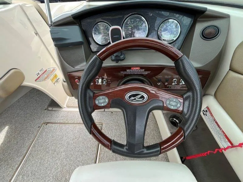 Slide: The Image of 2007 Sea Ray 210 Select boat dashboard with steering wheel and instrument panel. - 43