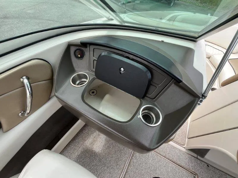 Slide: The Image of 2007 Sea Ray 210 Select boat interior with cup holders and storage compartment. - 44