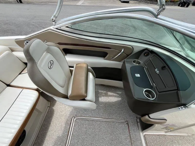 Slide: The Image of 2007 Sea Ray 210 Select boat interior with beige seating and dashboard. - 45