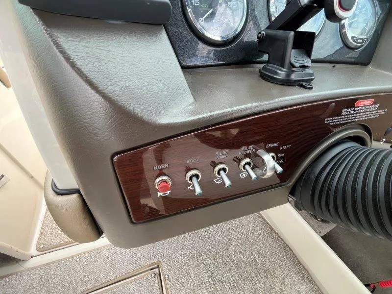 Slide: The Image of Control panel of a 2007 Sea Ray 210 Select boat with switches and gauges. - 48