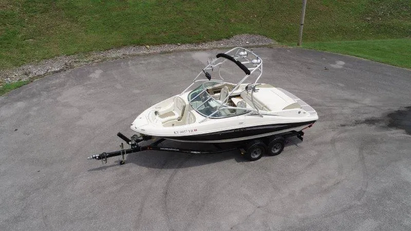 Slide: The Image of 2007 Sea Ray 210 Select boat on trailer, parked on paved surface. - 5