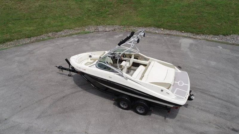 Slide: The Image of 2007 Sea Ray 210 Select boat on trailer, aerial view, parked on paved surface. - 6